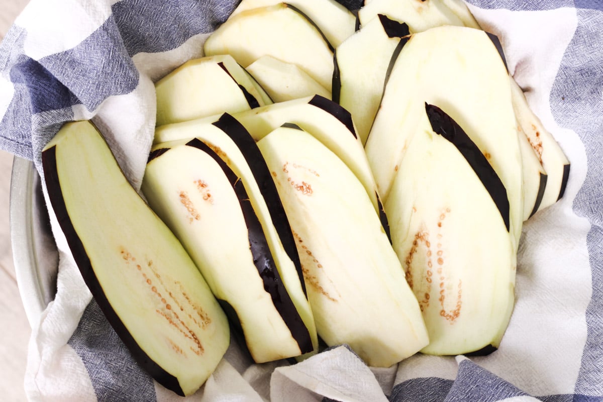 overhead image of eggplant slices for Parmigiana di Melanzane (Traditional Eggplant Parmigiana).