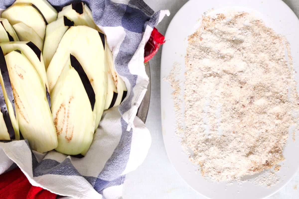 overhead image of breading eggplant for Parmigiana di Melanzane (Traditional Eggplant Parmigiana).