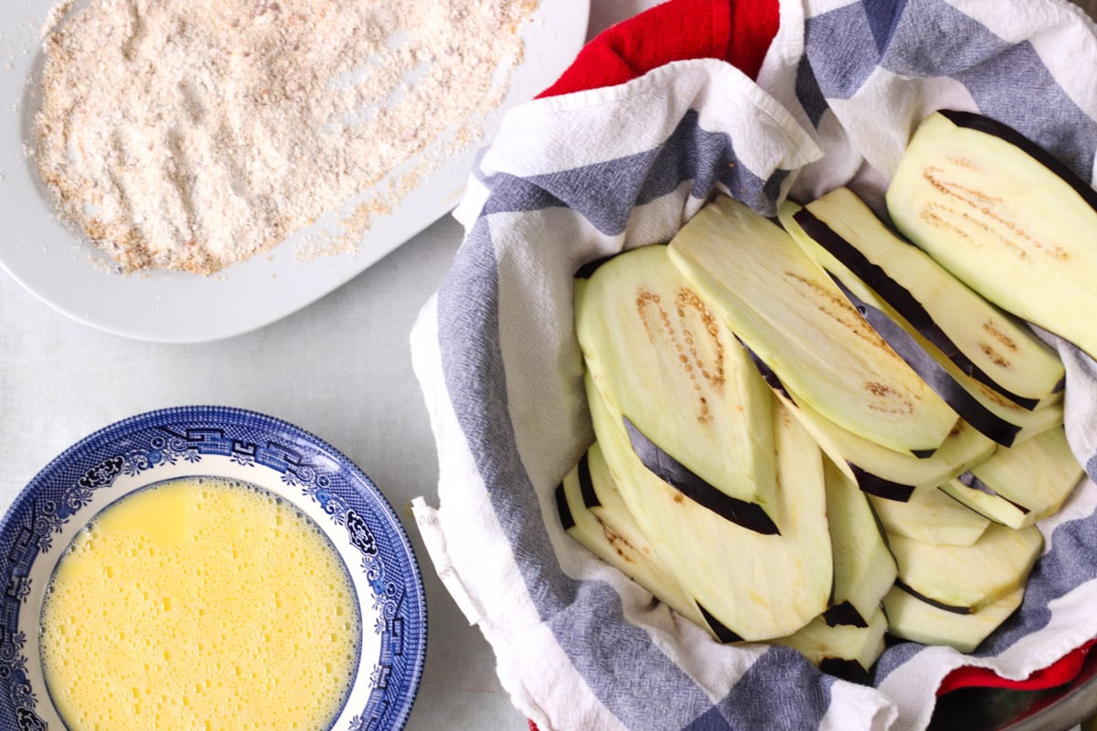 overhead image of breading eggplant for Parmigiana di Melanzane (Traditional Eggplant Parmigiana).