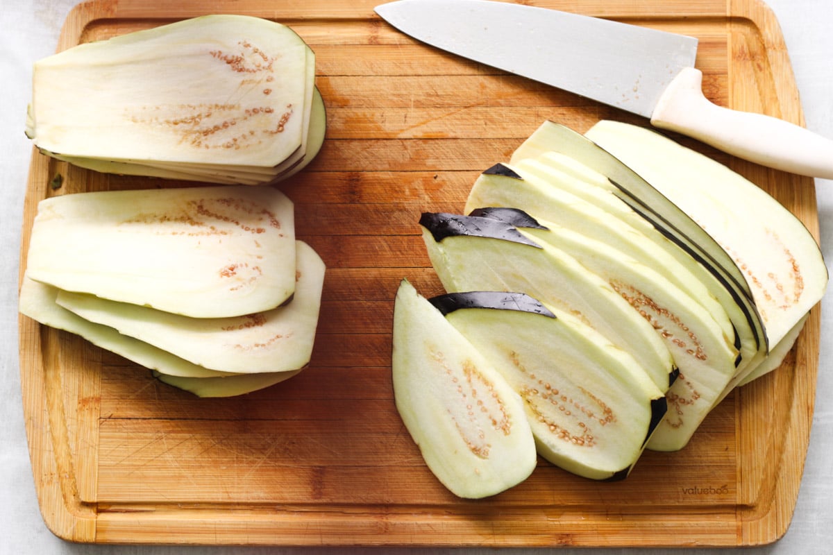 overhead image of slicing eggplant for Parmigiana di Melanzane (Traditional Eggplant Parmigiana).