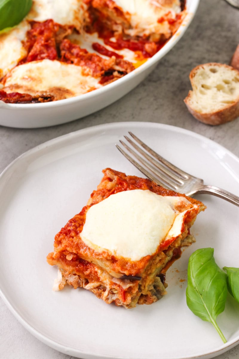 close up image of Parmigiana di Melanzane (Traditional Eggplant Parmigiana)on a white plate.