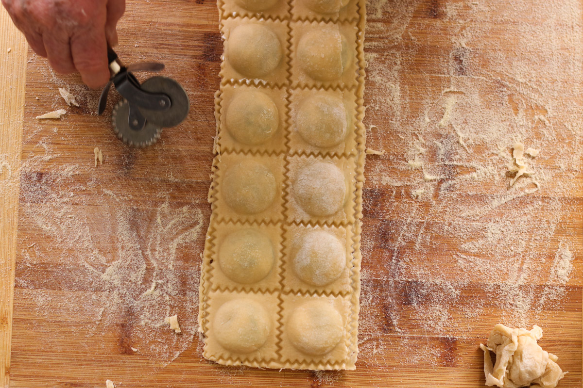 close up image of cutting ravioli.