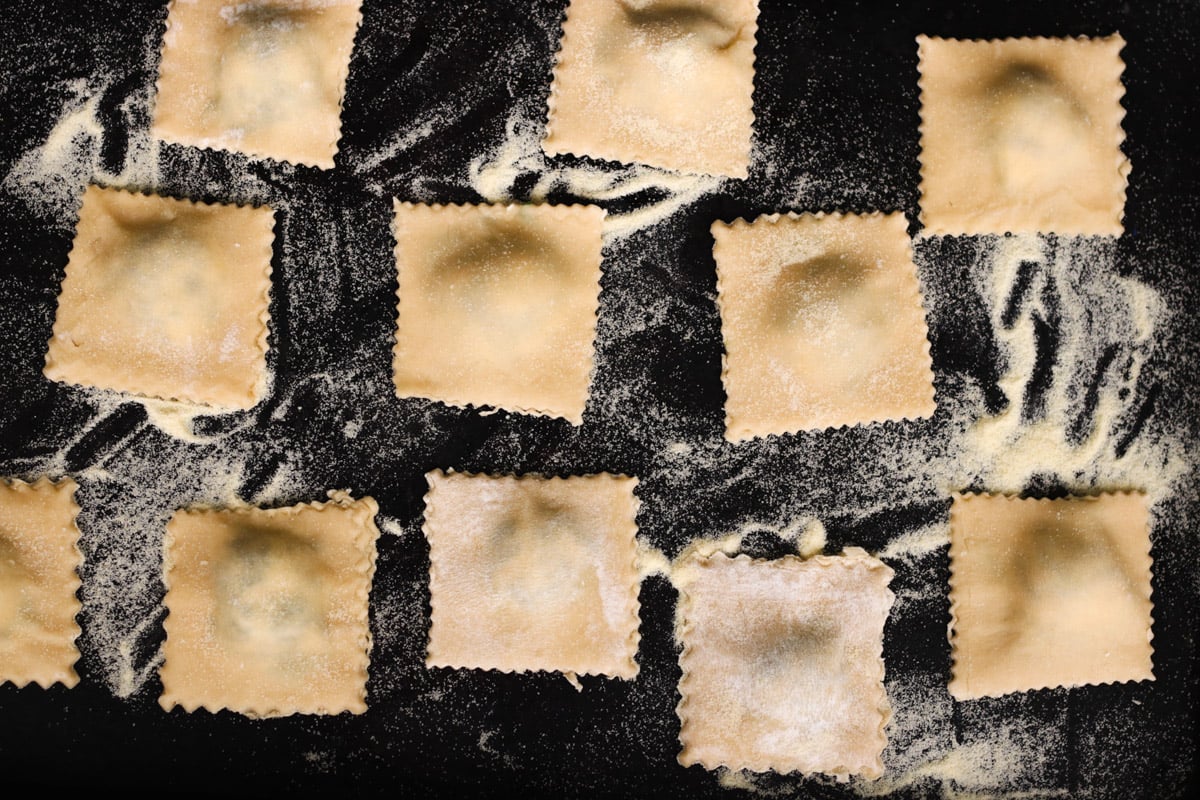 close up image of ravioli on a baking sheet.