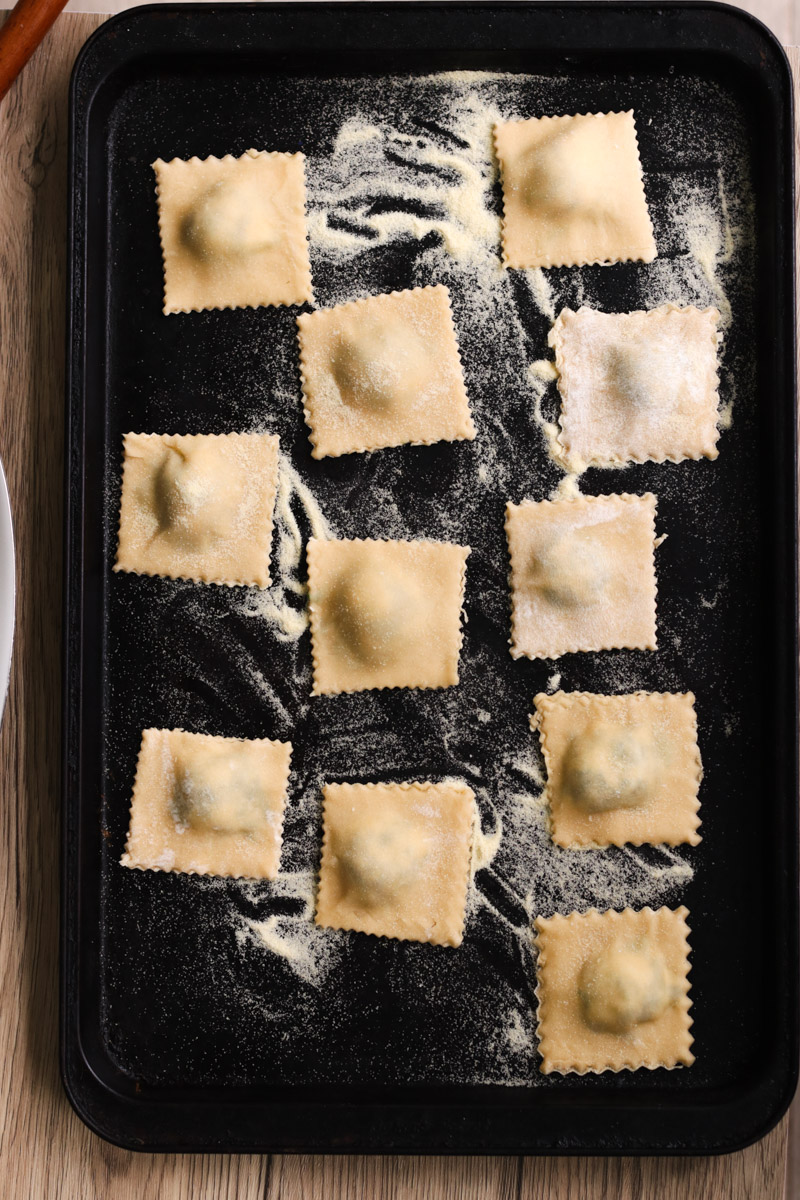 closeup image of ravioli on a baking tray.