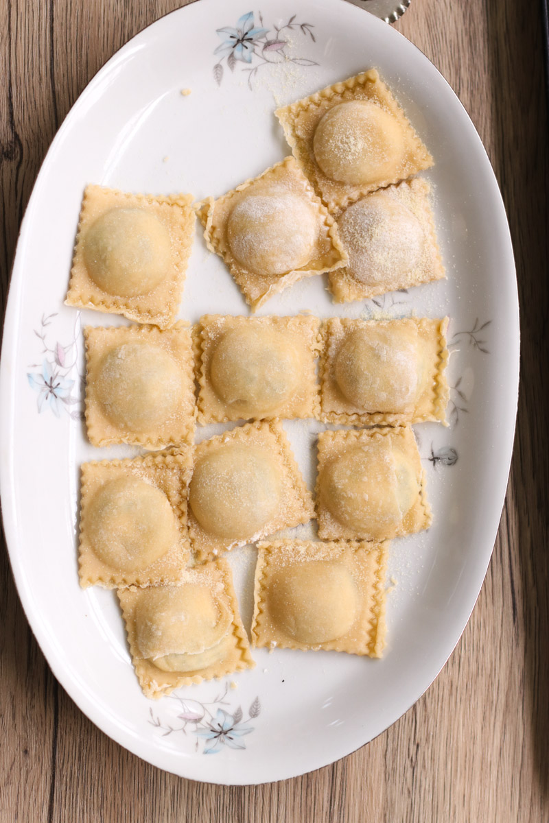 close up image of ravioli on a white plate.