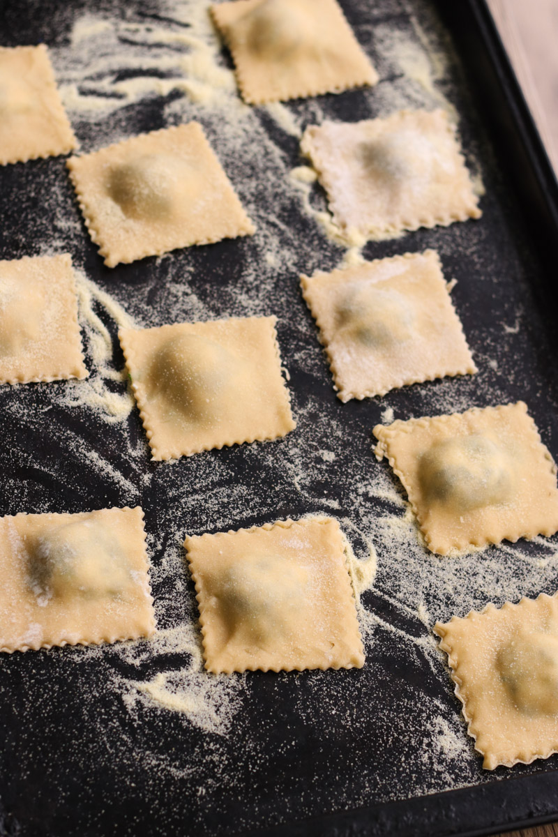 close up image of ravioli on a baking sheet.