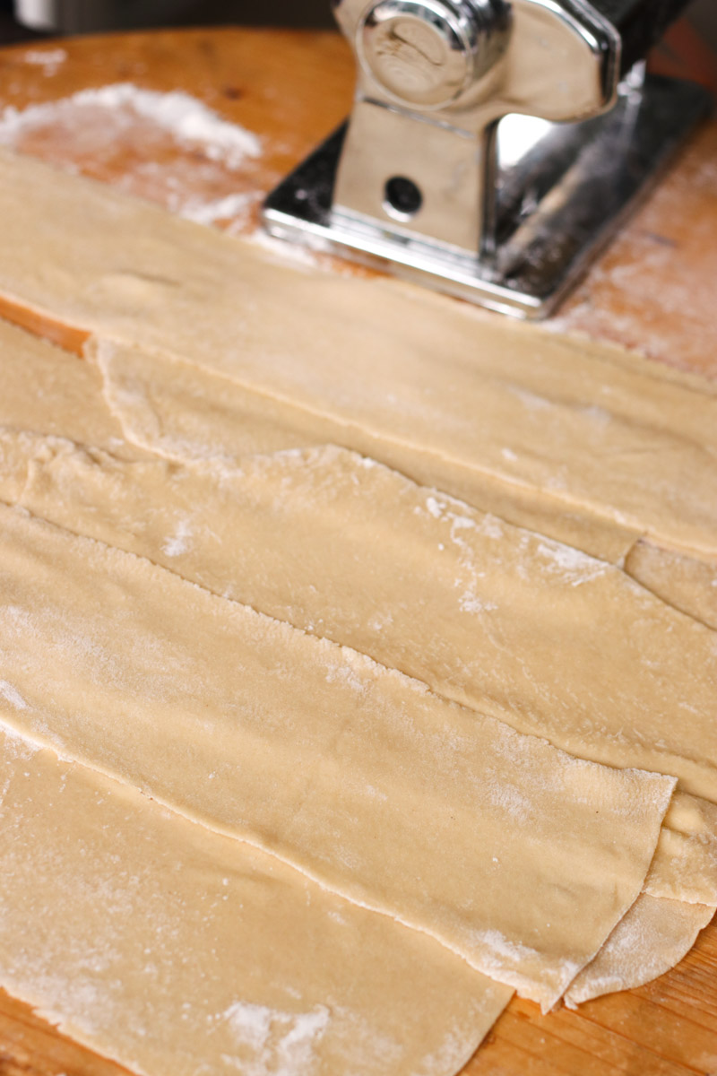 close up image of rolling out the pasta sheets.