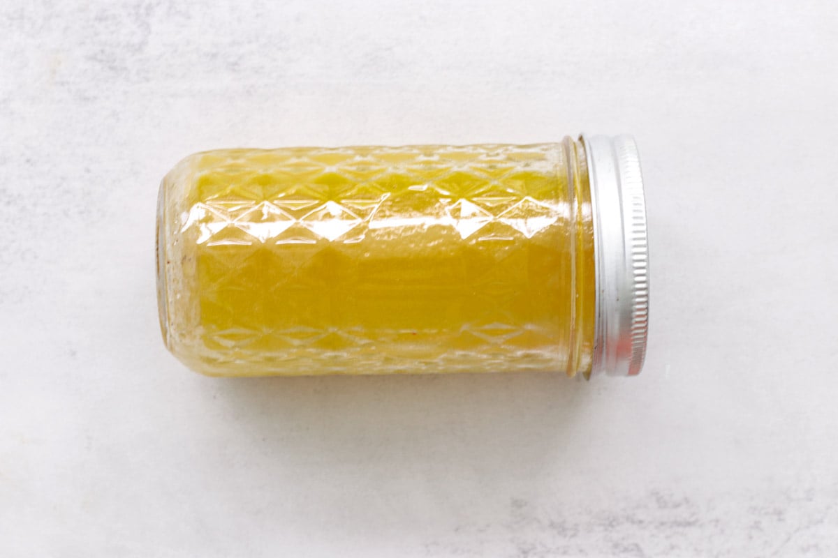 a salad dressing in a glass jar.