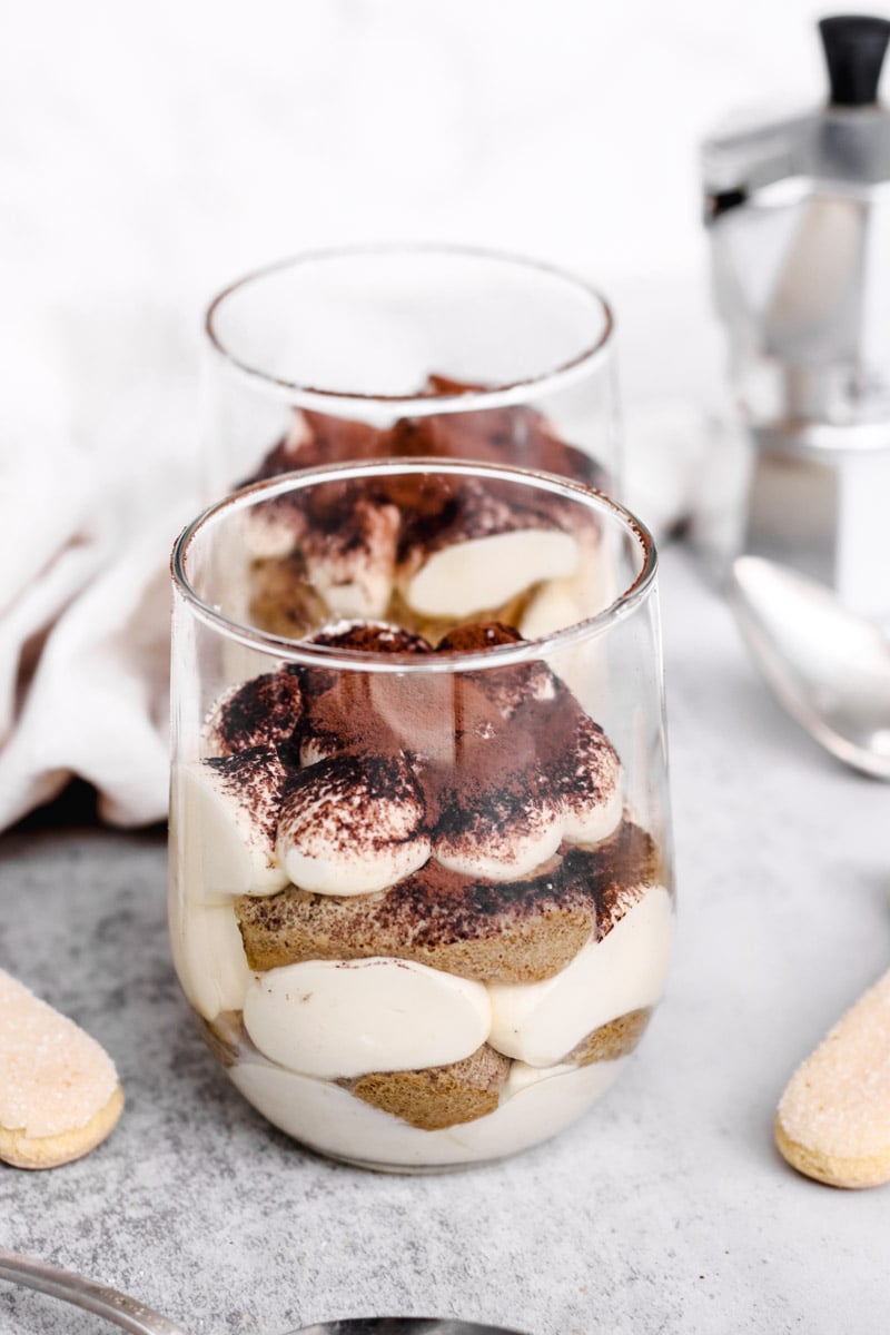 close up image of authentic Italian tiramisu recipe in glasses.