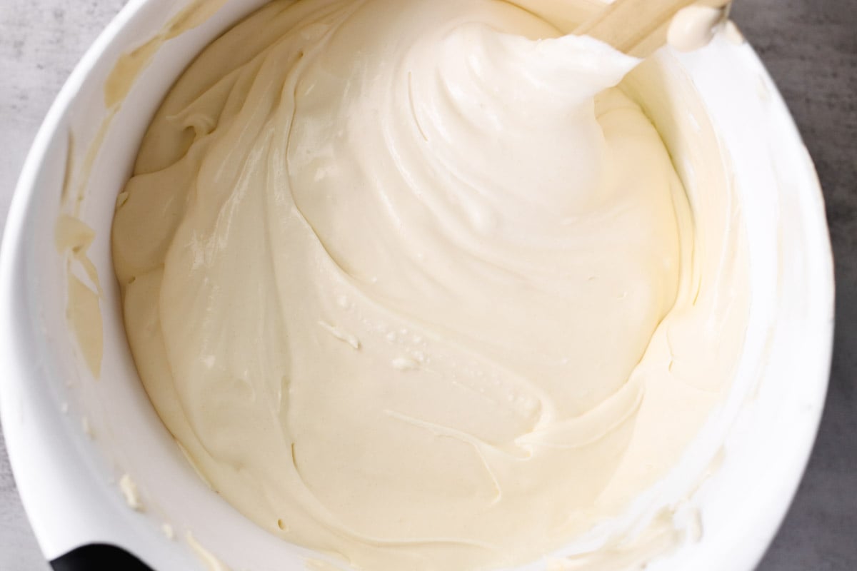 overhead image of folding cream in a white bowl.