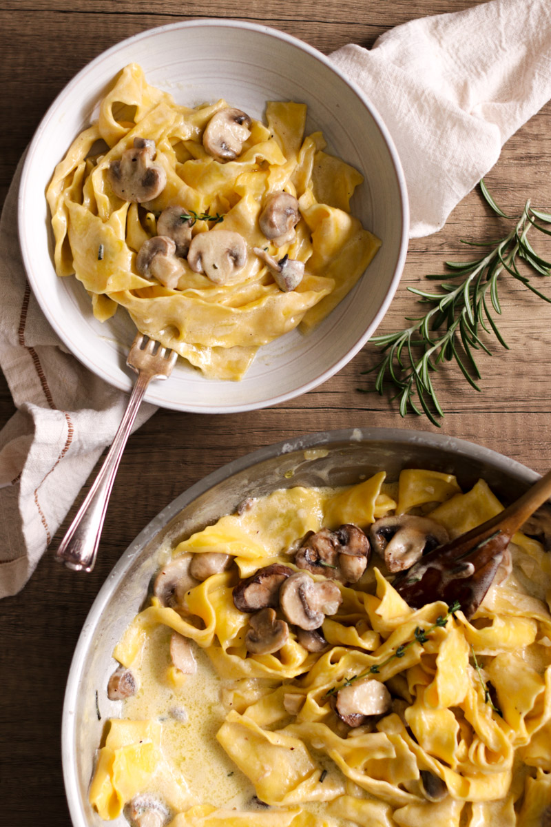 close up image of creamy mushroom pappardelle in a skillet. 