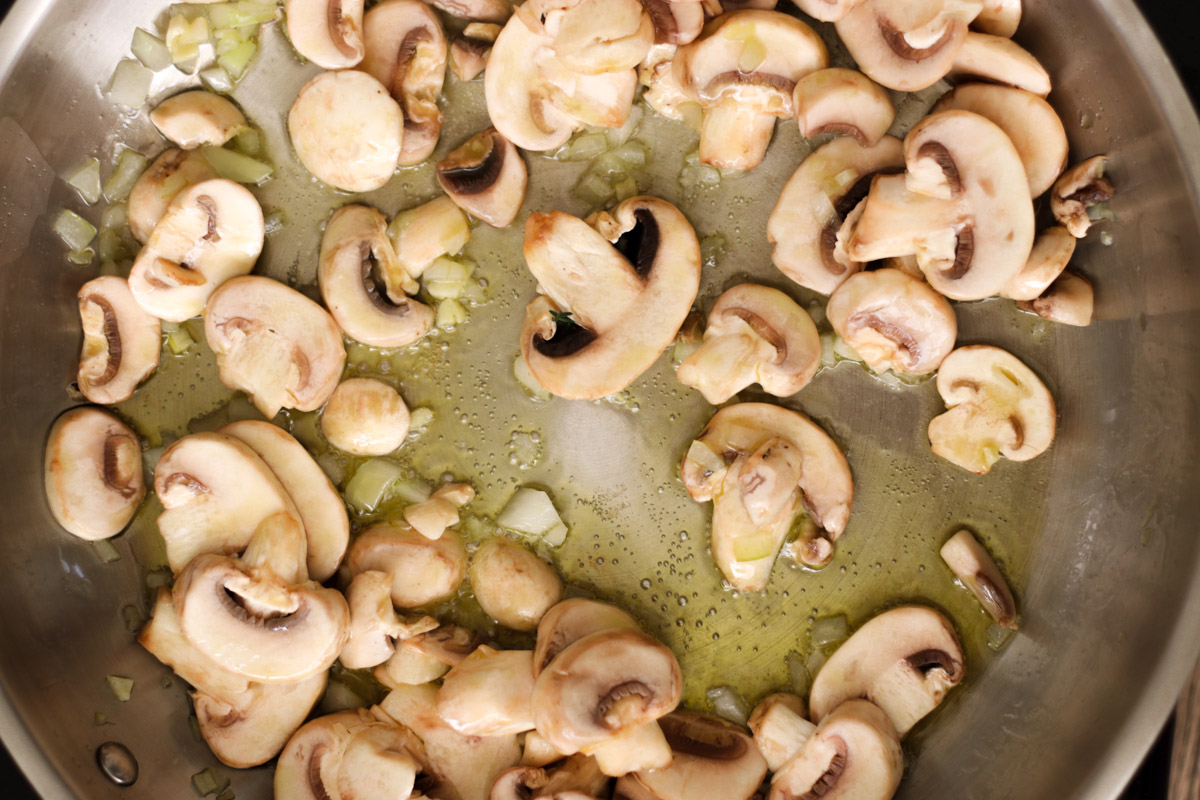 image of cooking mushrooms in a skillet. 