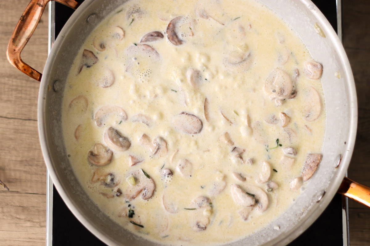 overhead image of cooking mushrooms in a cream sauce. 