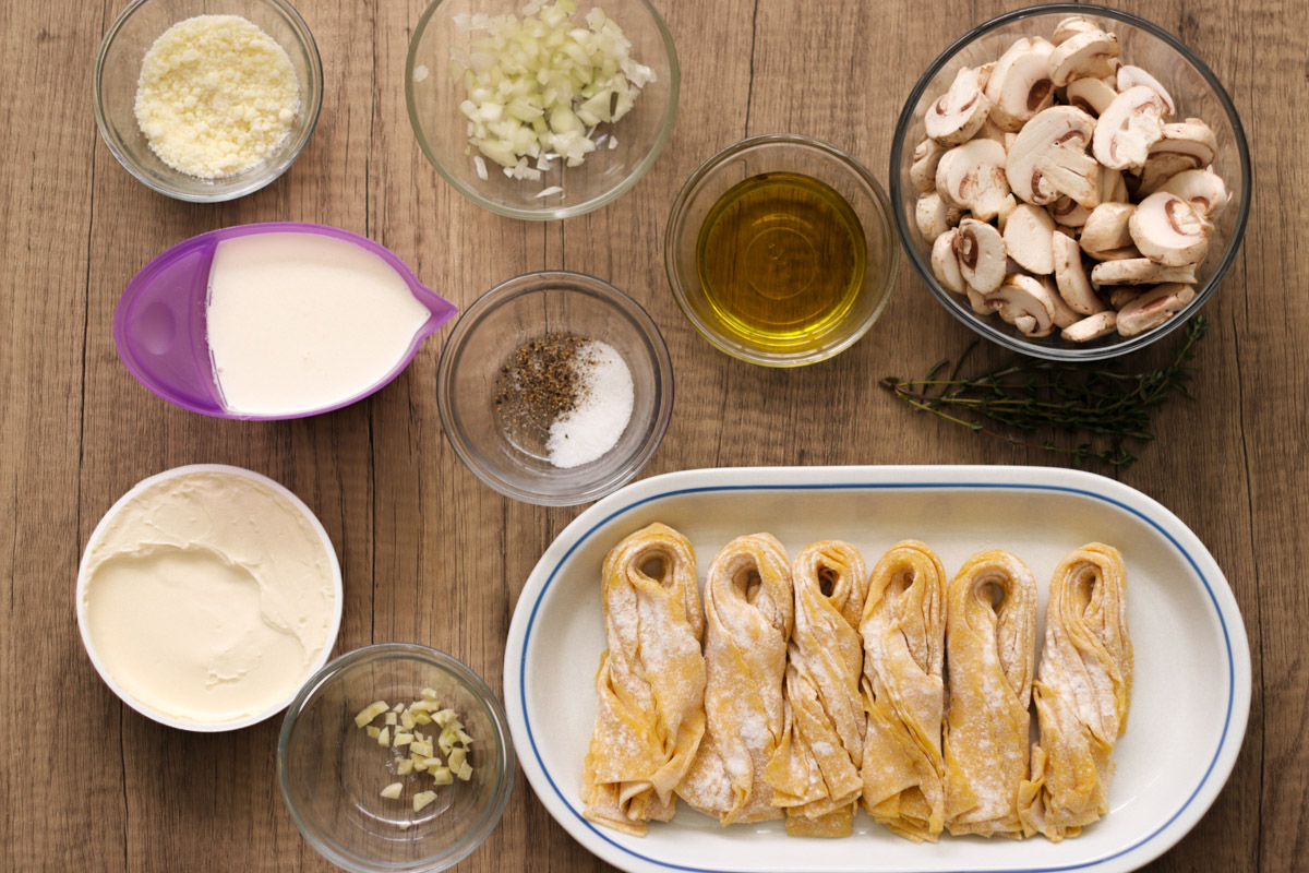 overhead image of ingredients to make pasta with creamy mushroom sauce.