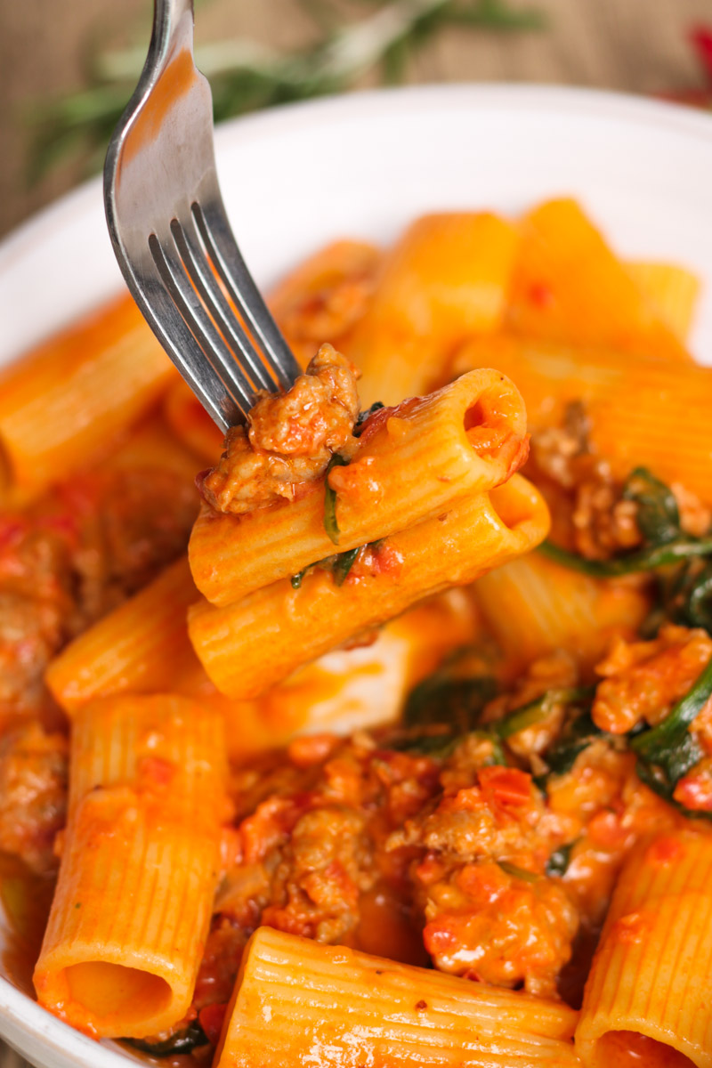 close up image of sausage rigatoni on a fork. 