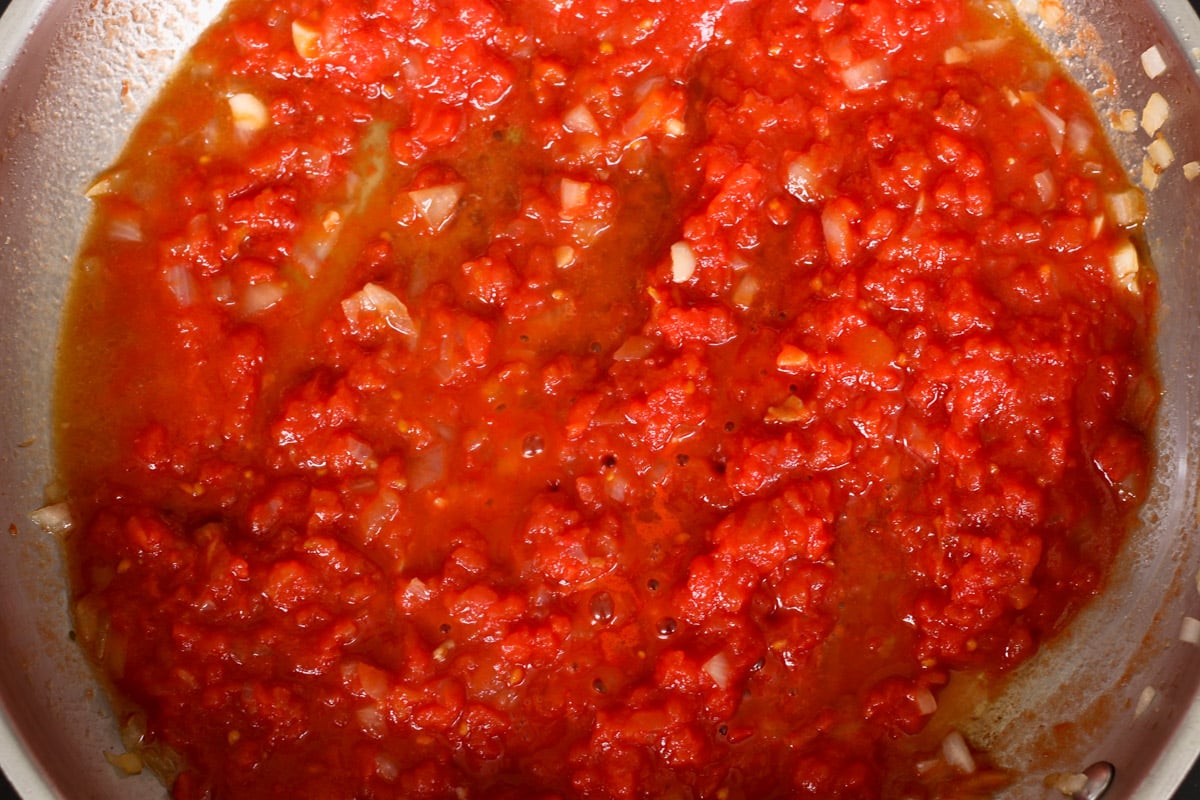 close up image of cooking sauce in a skillet.
