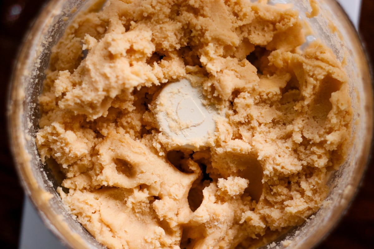 close up image of making dough for almond thumbprint cookies.