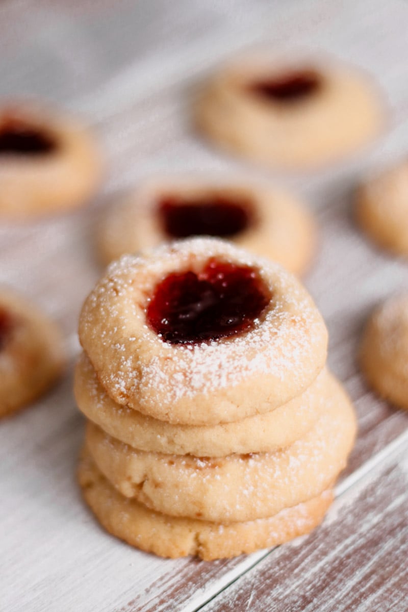 close up image of almond thumbprint cookies.
