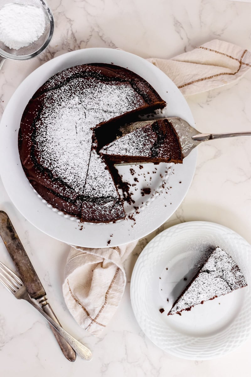 overhead image of an Italian chocolate cake on a white plate.