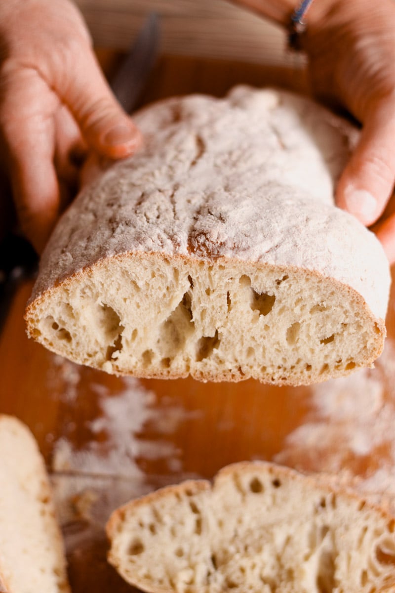 close up image Italian ciabatta bread on cutting board.