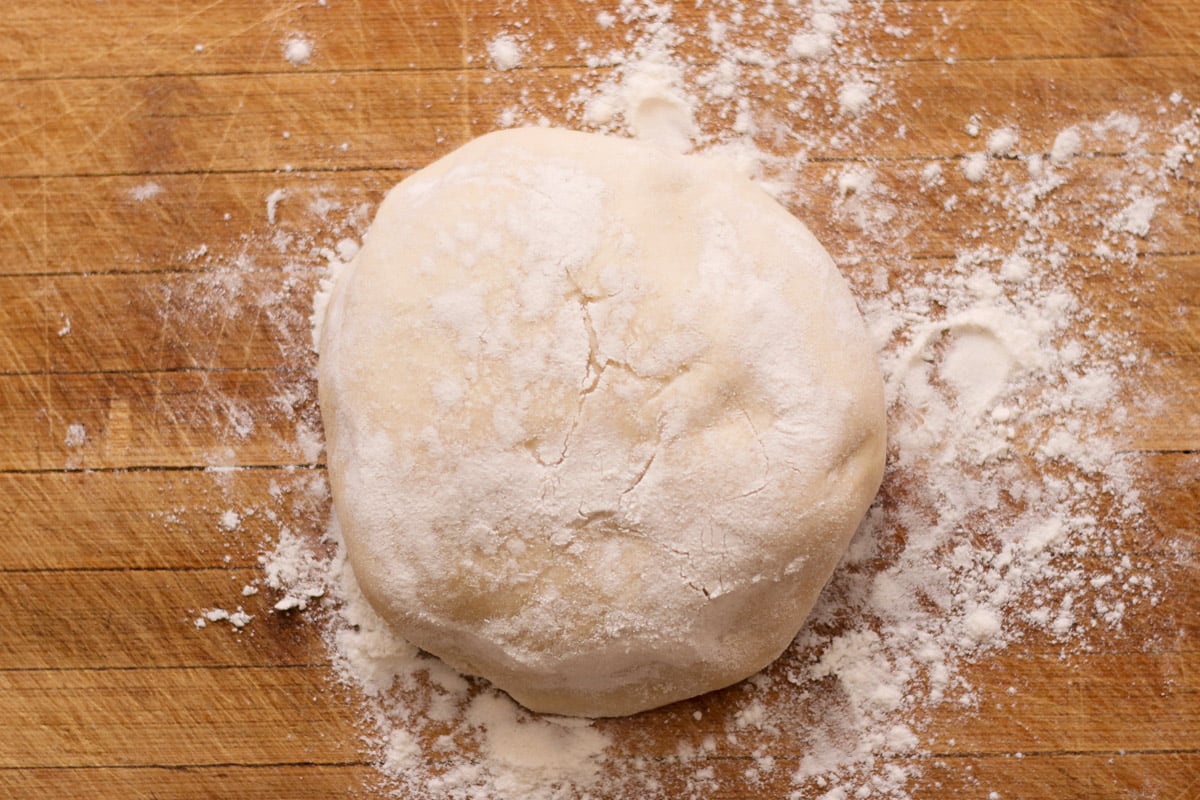 overhead image of making ciabatta dough on a wood board.