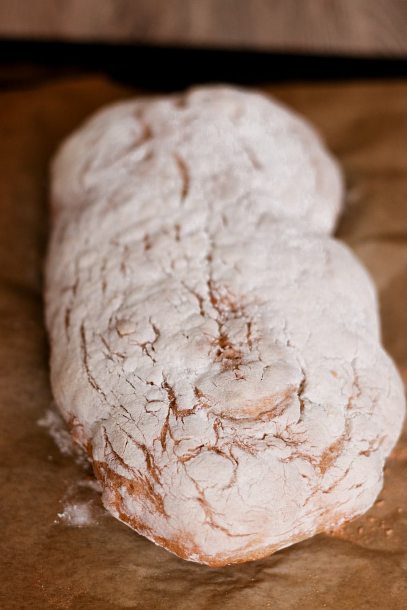 close up image of Italian ciabatta bread on cutting board.