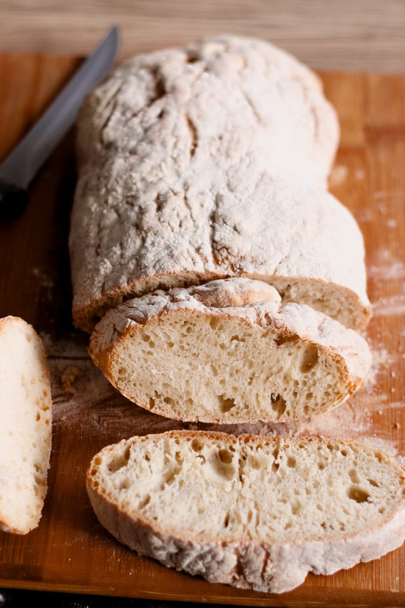 close up image of Italian ciabatta bread on cutting board.