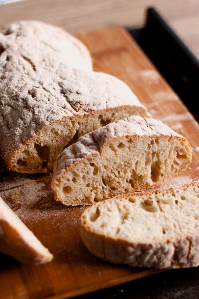 Italian ciabatta bread on cutting board.