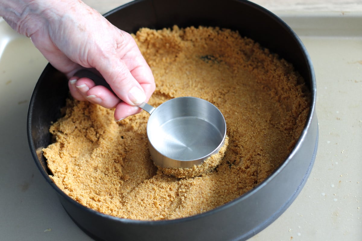 close up image of pressing crust in a pan.
