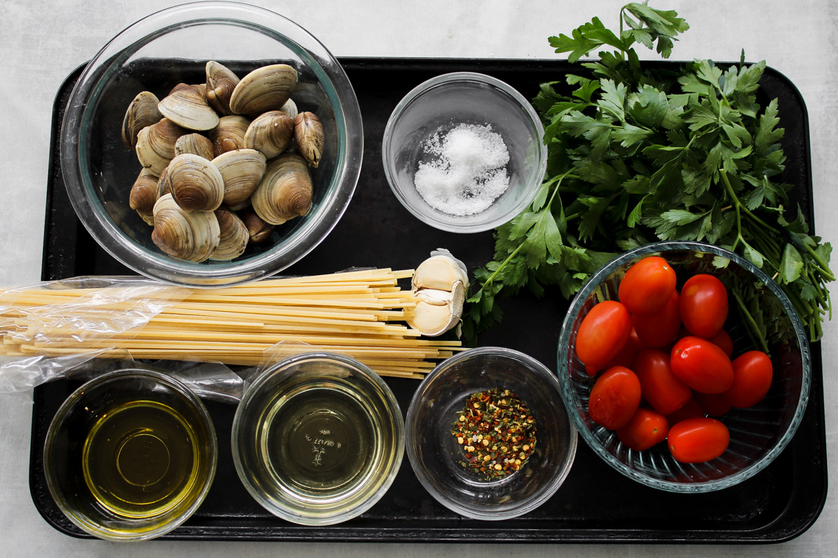 overhead image of ingredients to make pasta and clams.