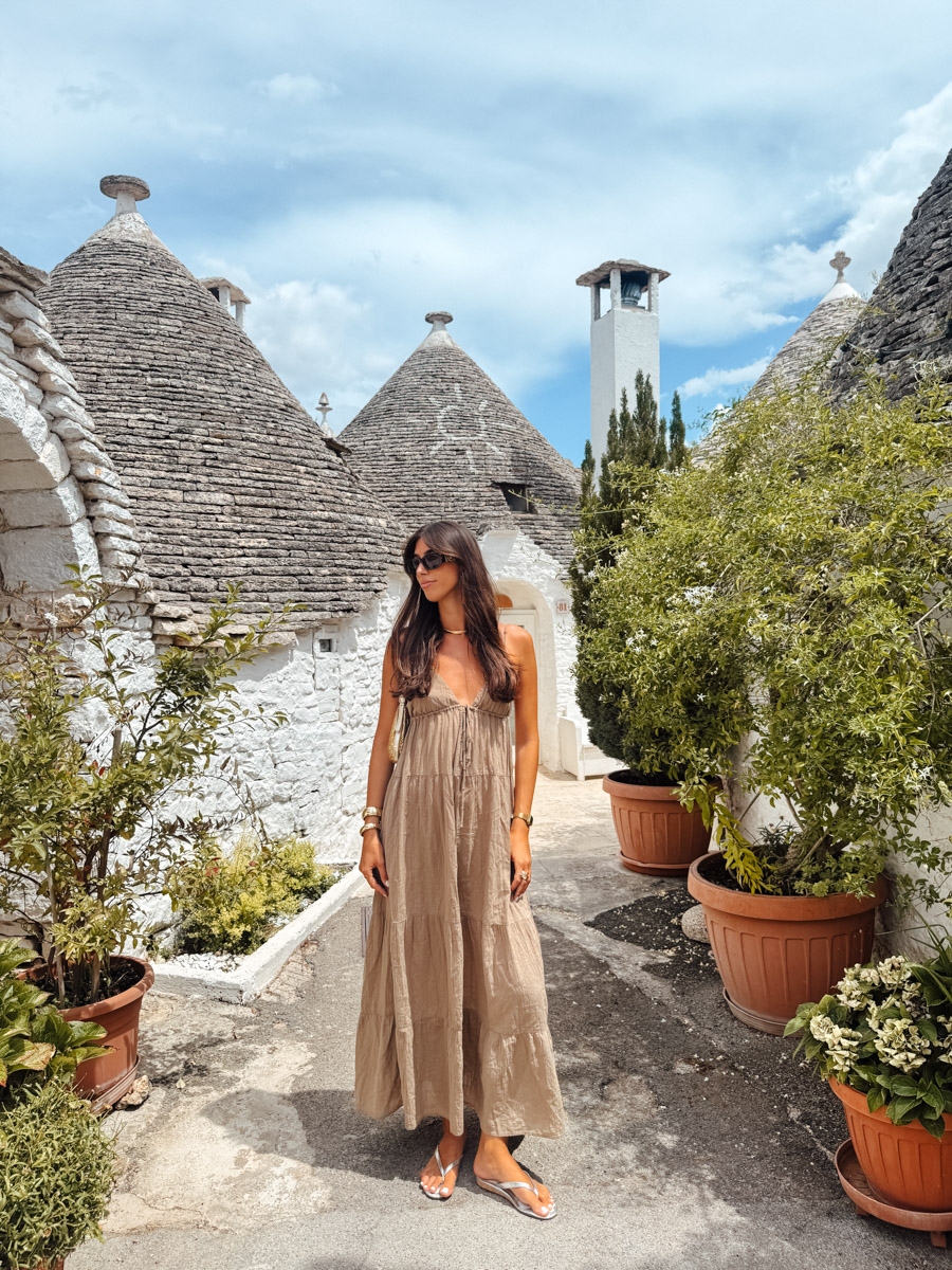 Tiny whitewashed trullo house in Alberobello converted into a souvenir shop