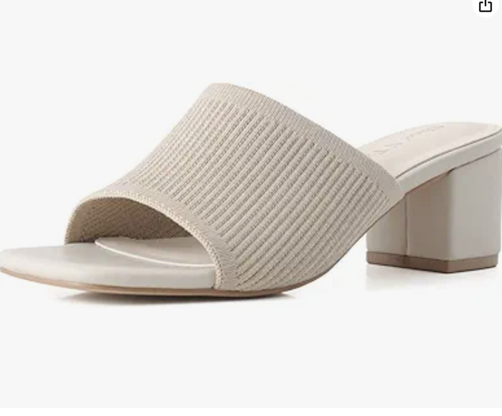 A beige open-toe block-heeled sandal with a wide ribbed fabric strap and a light soleāan ideal choice for effortless chic when deciding what to wear in Italy, displayed on a white background.