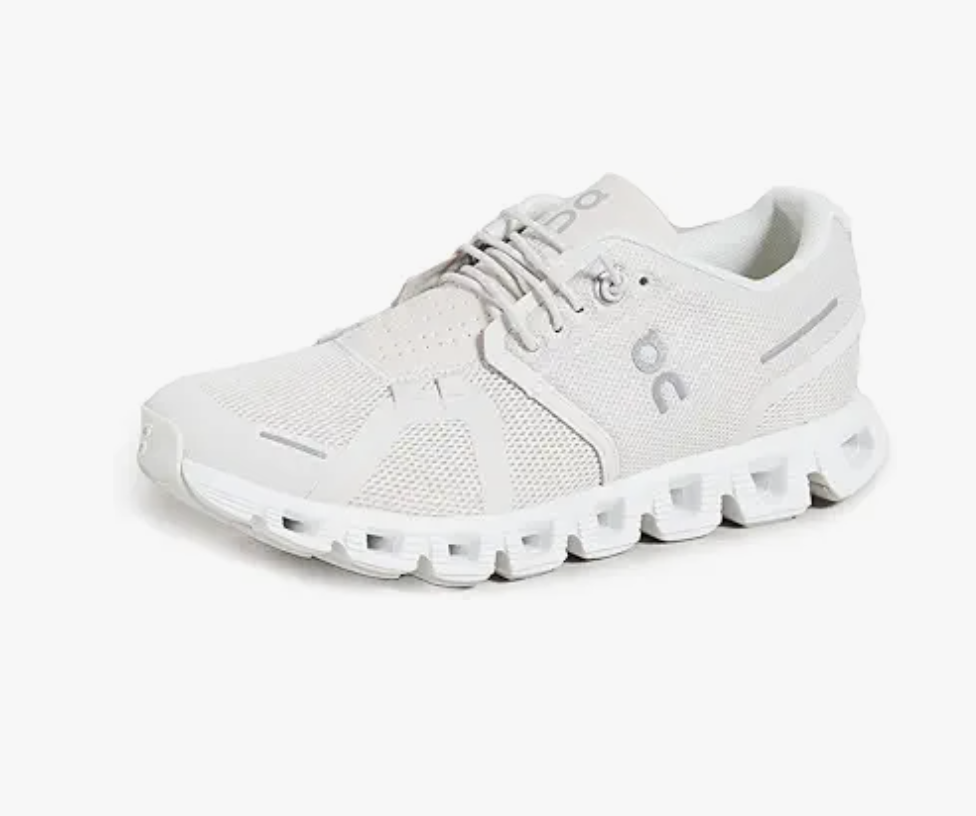 A light gray athletic sneaker with a mesh upper and unique, segmented white sole, featuring the On brand logo on the side and tongue-perfect for those wondering what to wear in Italy for comfort and style.